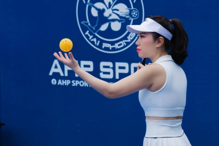 Pickleball player holding a ball