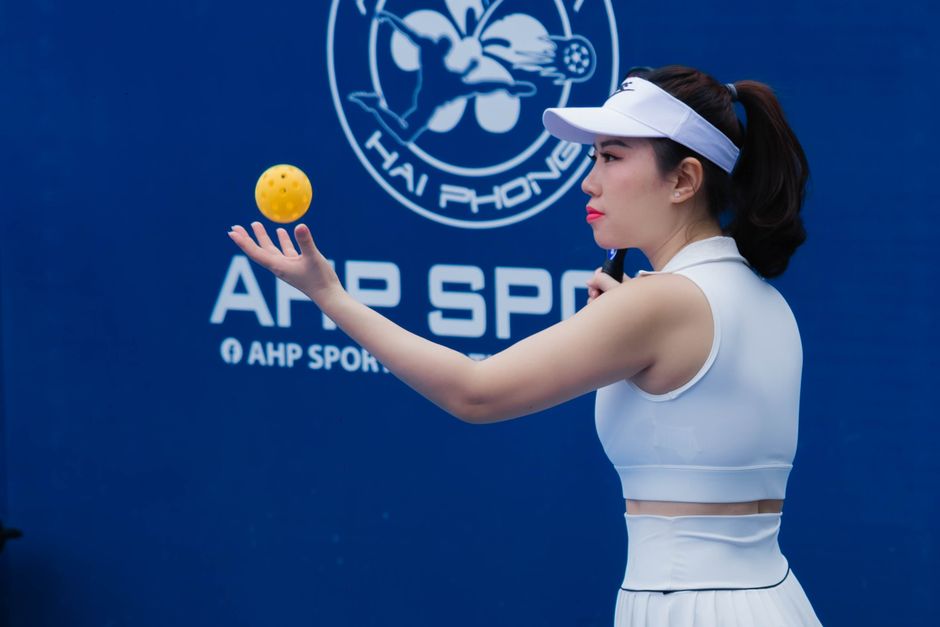 Pickleball player holding a ball