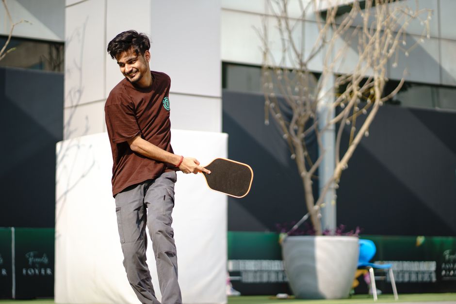 Outdoor player swinging an elongated power paddle like the Joola Perseus Pro V