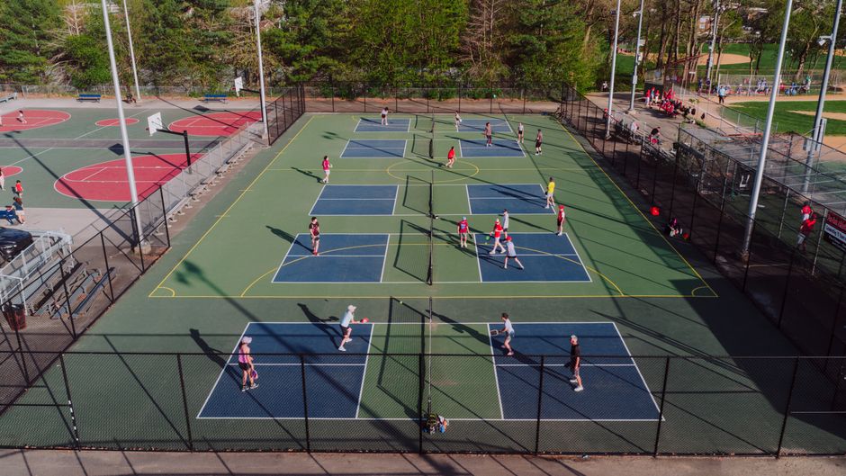 Busy outdoor pickleball courts with players