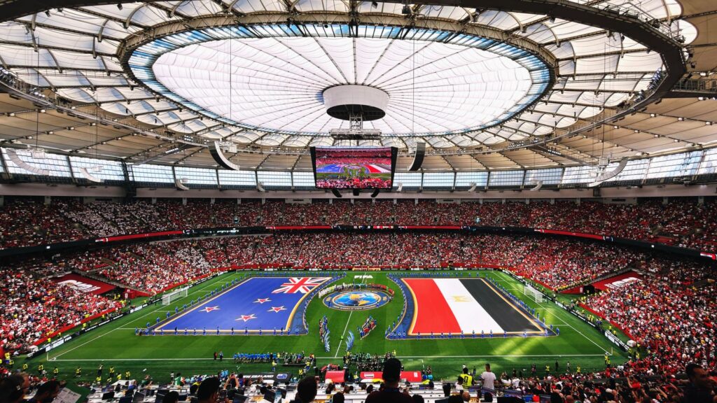 International flags flying in a packed stadium - Pickleball World Cup goes global