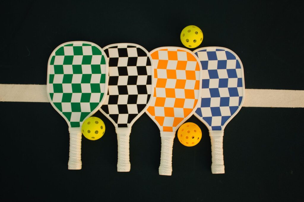 Several pickleball paddles side by side showing widebody shapes suited to beginners