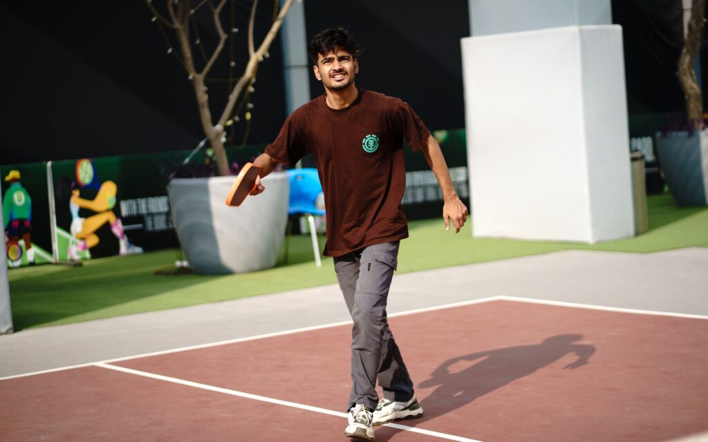 Player shifting to cover the sideline during a pickleball doubles rally