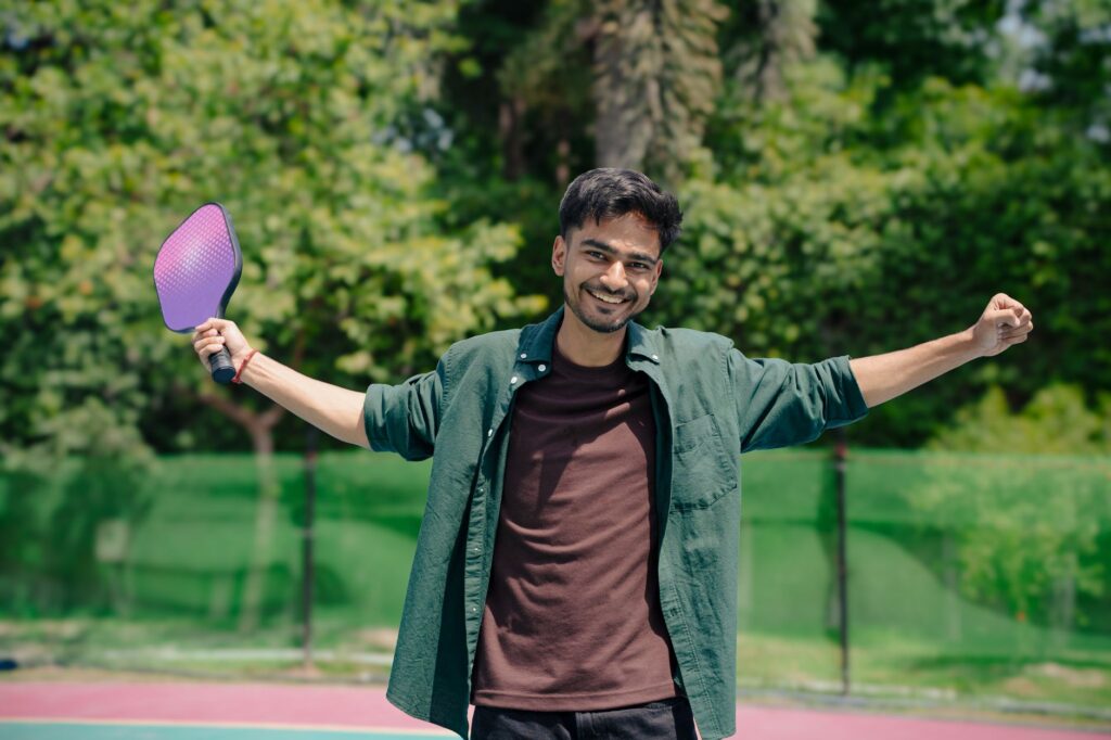 A pickleball player celebrating a win on an outdoor court, as amateurs do at the PPA National Championships 2026