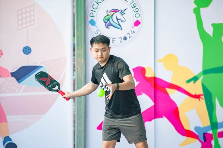 A pickleball player mid-rally in league competition, the organized play the USA Pickleball league integration targets