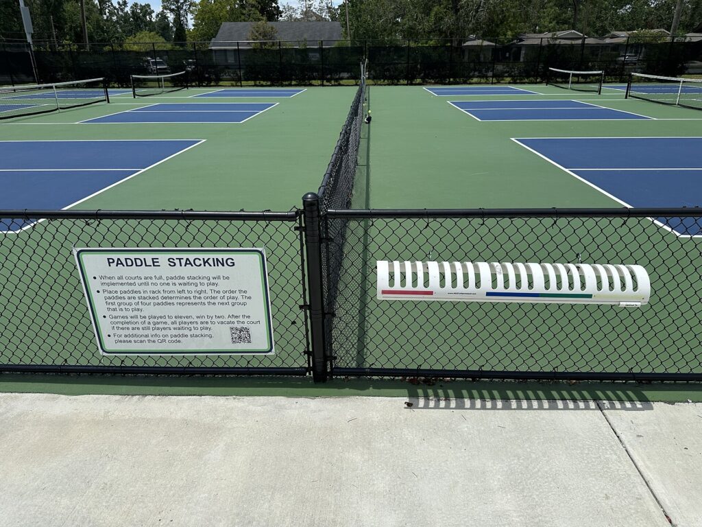 A paddle stacking rack beside public pickleball courts, a rec-court version of the pick order that explains how the MLP draft works