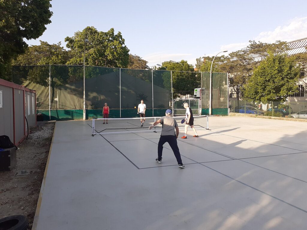 A doubles pickleball match in progress on an outdoor court, illustrating coverage of the Kuala Lumpur Cup results