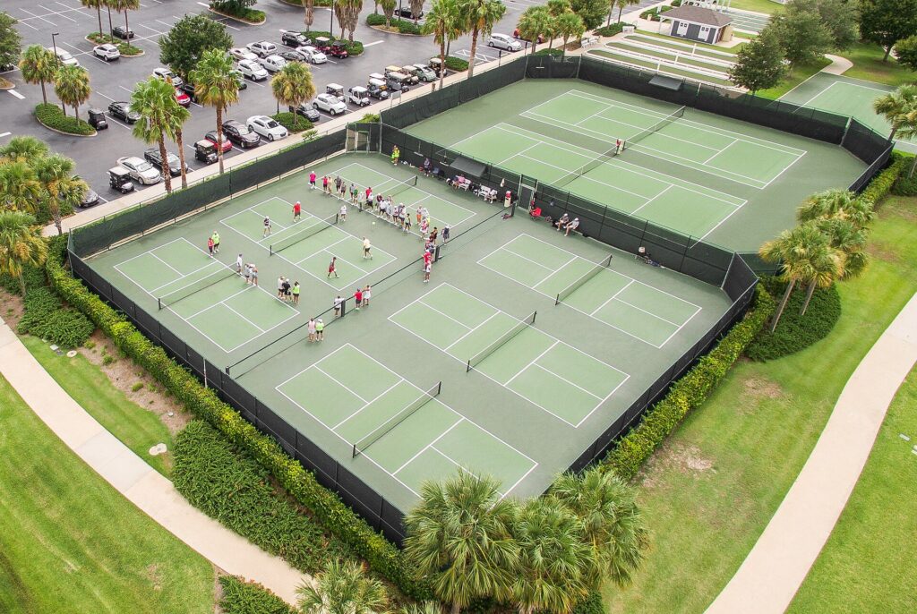 Aerial view of a busy multi-court pickleball complex during an event
