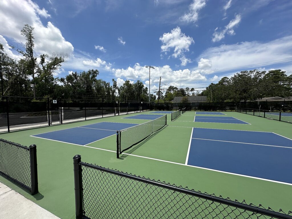Pickleball in cold weather: empty outdoor pickleball courts with nets up, ready for play