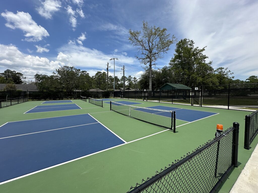 Numbered dedicated outdoor pickleball courts with kitchen lines and nets, illustrating pickleball in Waterville Maine