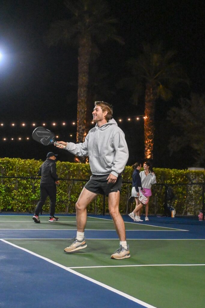 Pickleball player celebrating on an outdoor court at night under lights in Arizona, near the PPA Campus at Arizona Athletic Grounds