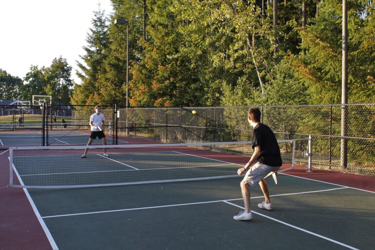 Two pickleball players in a baseline rally on an outdoor court, illustrating a pro spotlight on Anna Leigh Waters