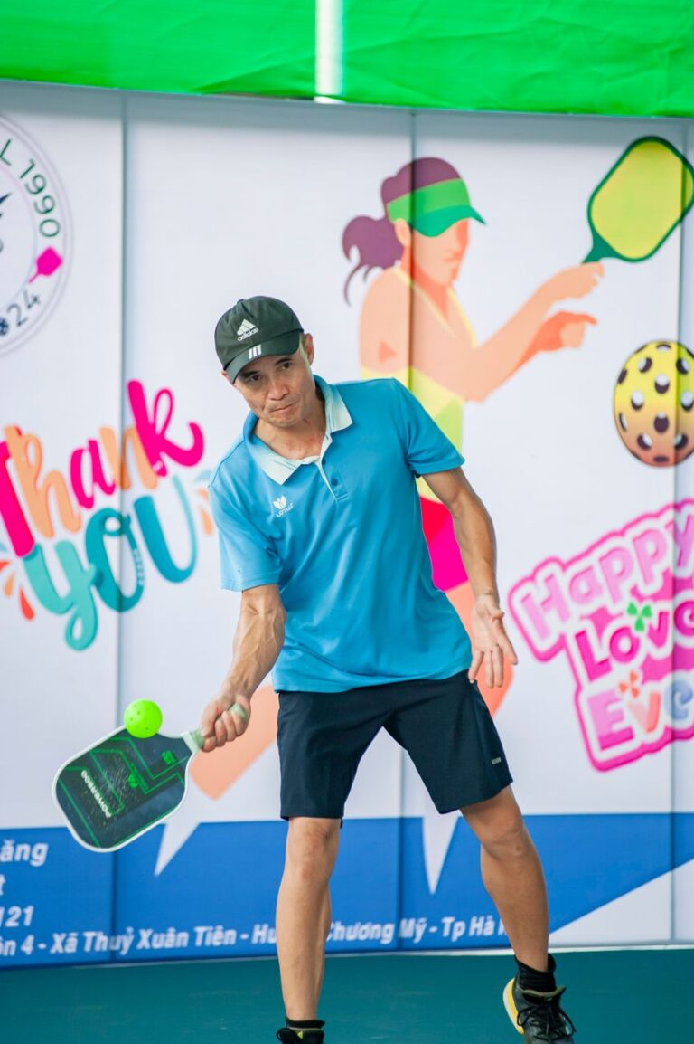 Player making low, compact contact on a forehand, the paddle position used for a push drop in pickleball