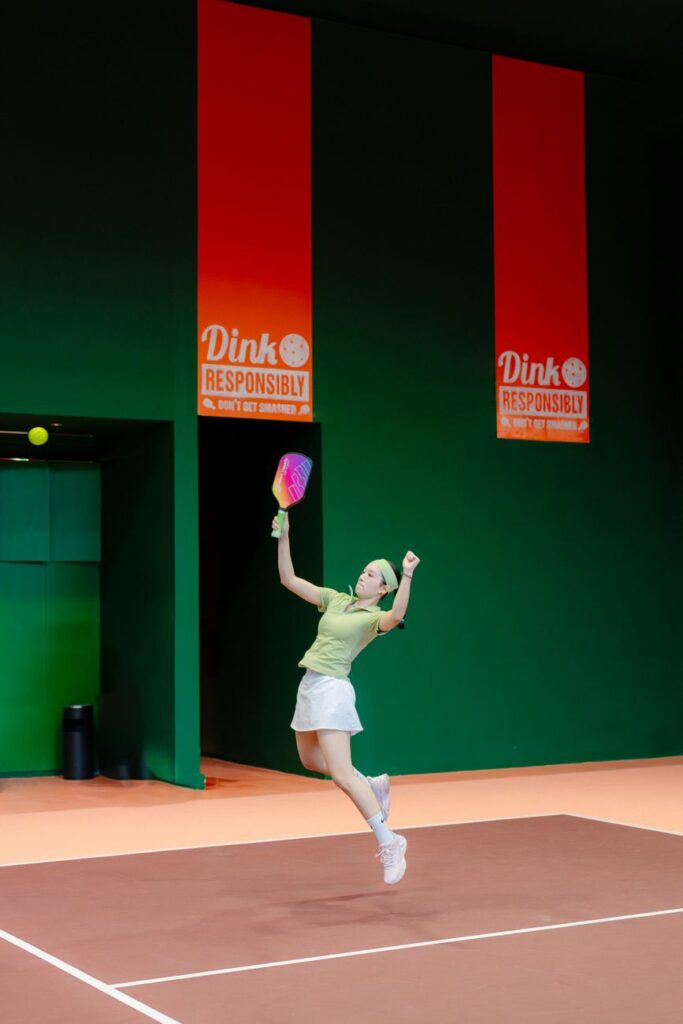 Indoor pickleball player leaping for an overhead - USA Pickleball sponsors news