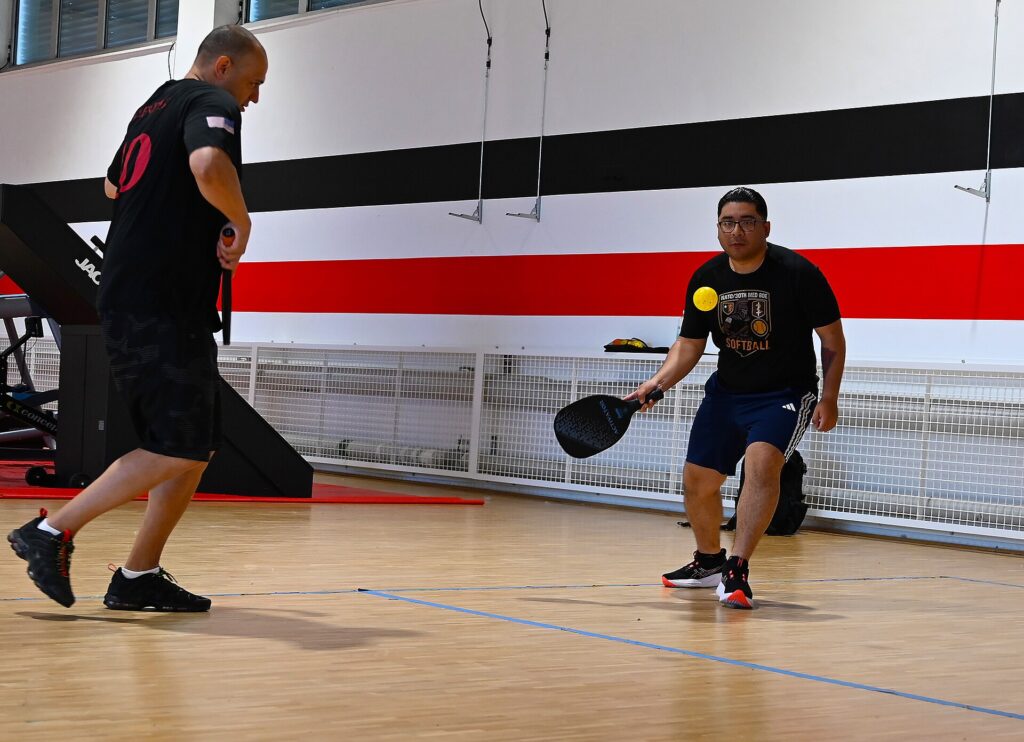 Indoor doubles rally with the paddle face toward the camera, for our all-court pickleball paddle explainer