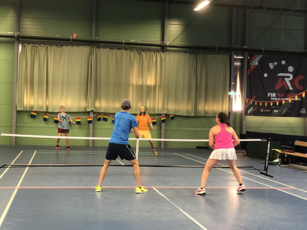Indoor doubles players ready at the kitchen line, where most questions about distraction in pickleball come up