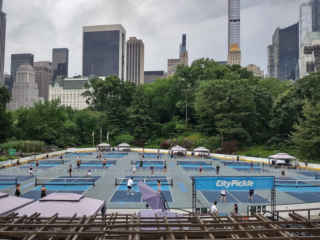 Rows of busy outdoor pickleball courts with permanent nets, the kind of new pickleball courts in Connecticut towns are adding