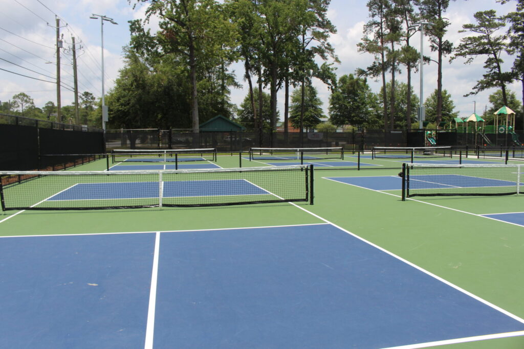 Outdoor public courts with nets in a town park, like the Recreation Park courts for pickleball in Middlebury VT
