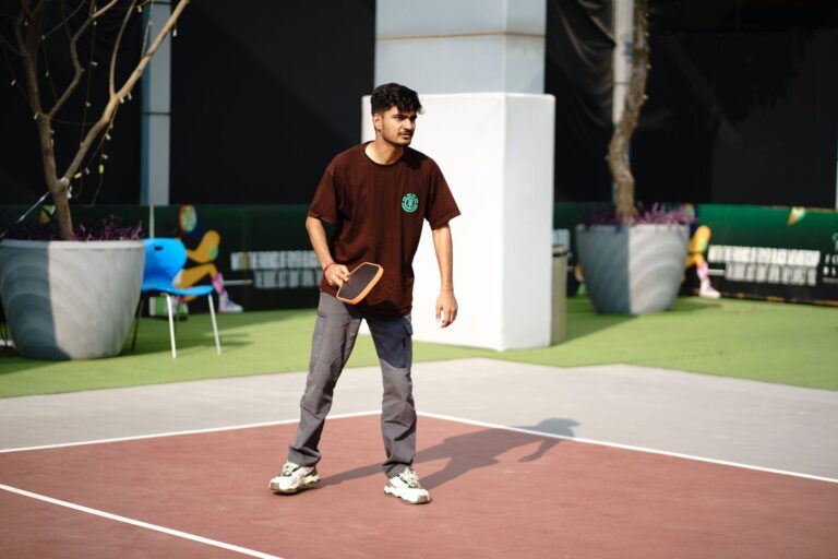 Player in ready position on a court, illustrating pickleball popularity by state and who plays