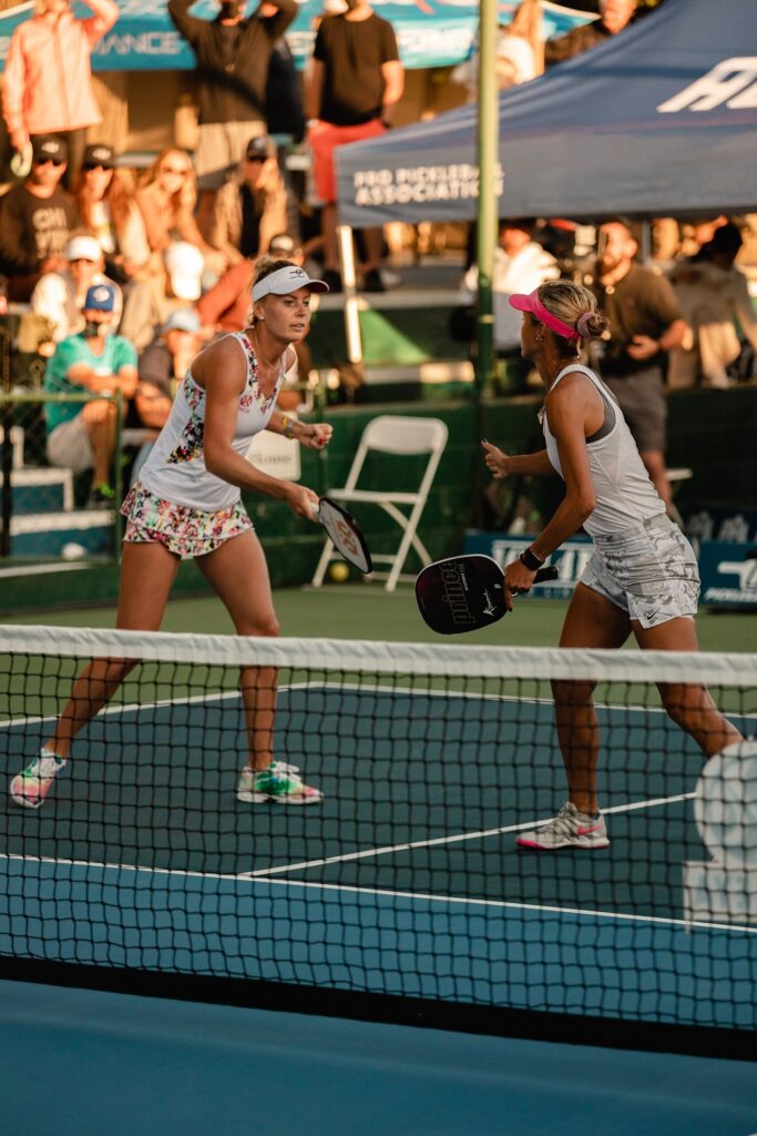 Two pro players at the net during a PPA doubles match, the setting of the pickleball taunting rule debate