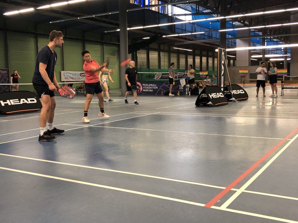 Doubles players hitting at the kitchen line indoors, the fast-hands game Anna Bright is known for