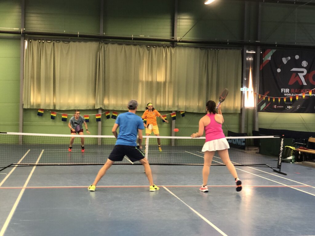 Doubles players at the net during an indoor rally, the all-court athletic game Tyson McGuffin is known for