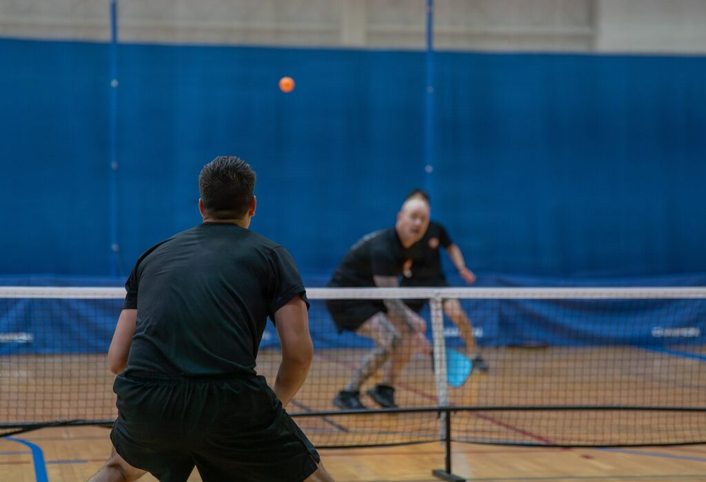Doubles player in ready position watching the ball, illustrating the right side in pickleball