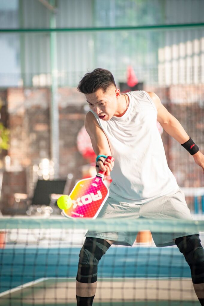 A player watches the ball onto the paddle face at contact, the focus a tweener in pickleball needs