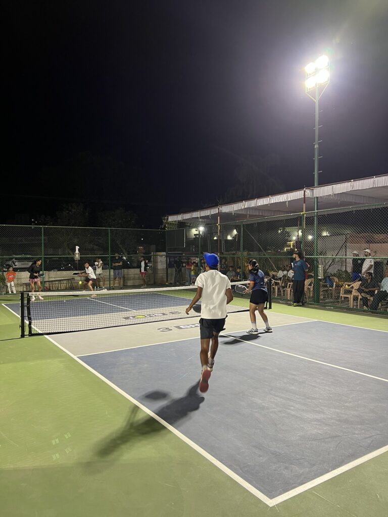 Doubles match under lights with spectators courtside, illustrating the Veolia Chicago Cup results recap